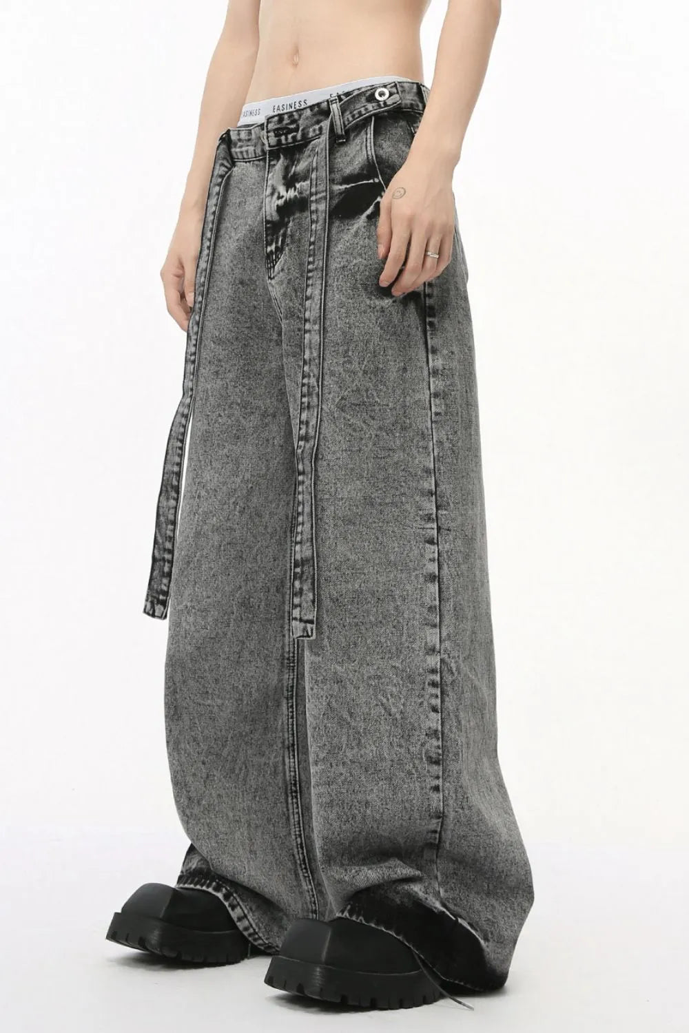 Acid wash belted palazzo jeans in dark wash, featuring a wide leg and tie belt.