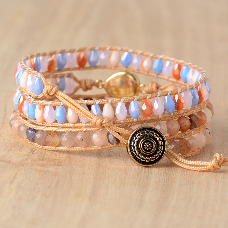 Multicolor gemstone and bead wrap bracelet with gold clasp and decorative button.