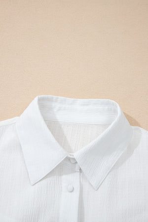 White crinkled texture button-down shirt with classic collar and button detail.