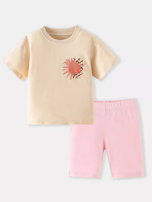 Toddler cotton set with peach sun graphic tee and pink bike shorts.