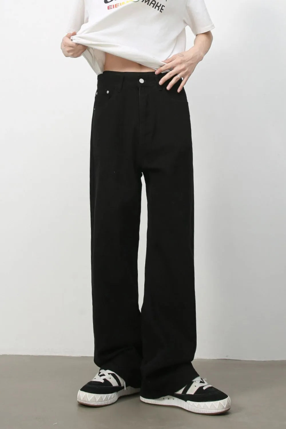 Black wide-leg rigid denim trousers with a relaxed fit.