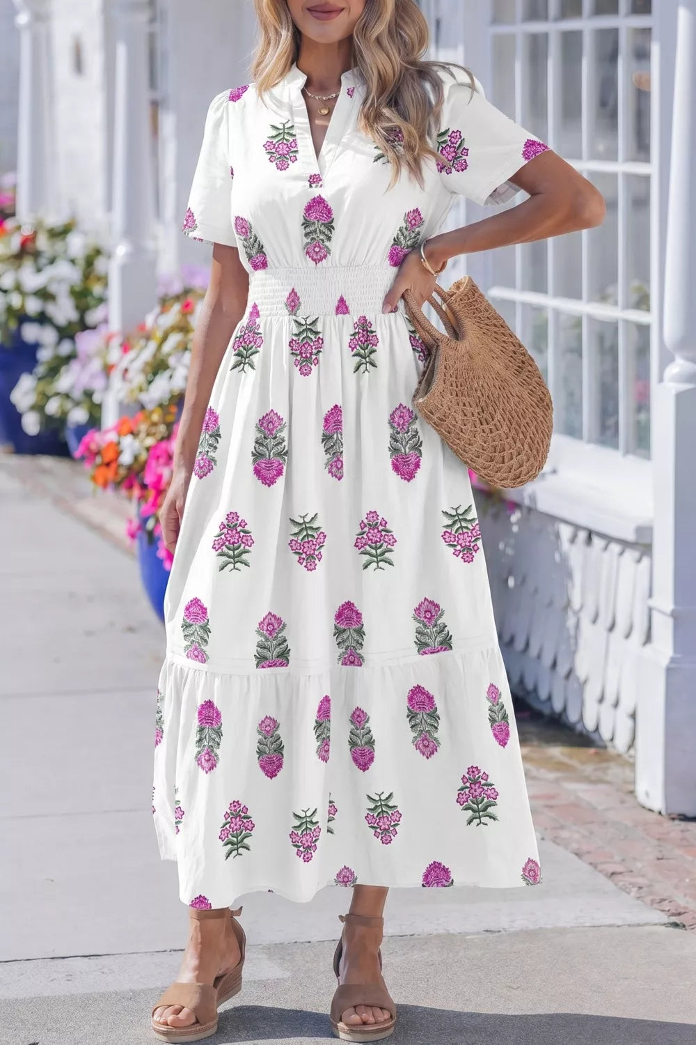 White cotton midi dress with pink floral print, V-neck, short sleeves, and smocked high waist.