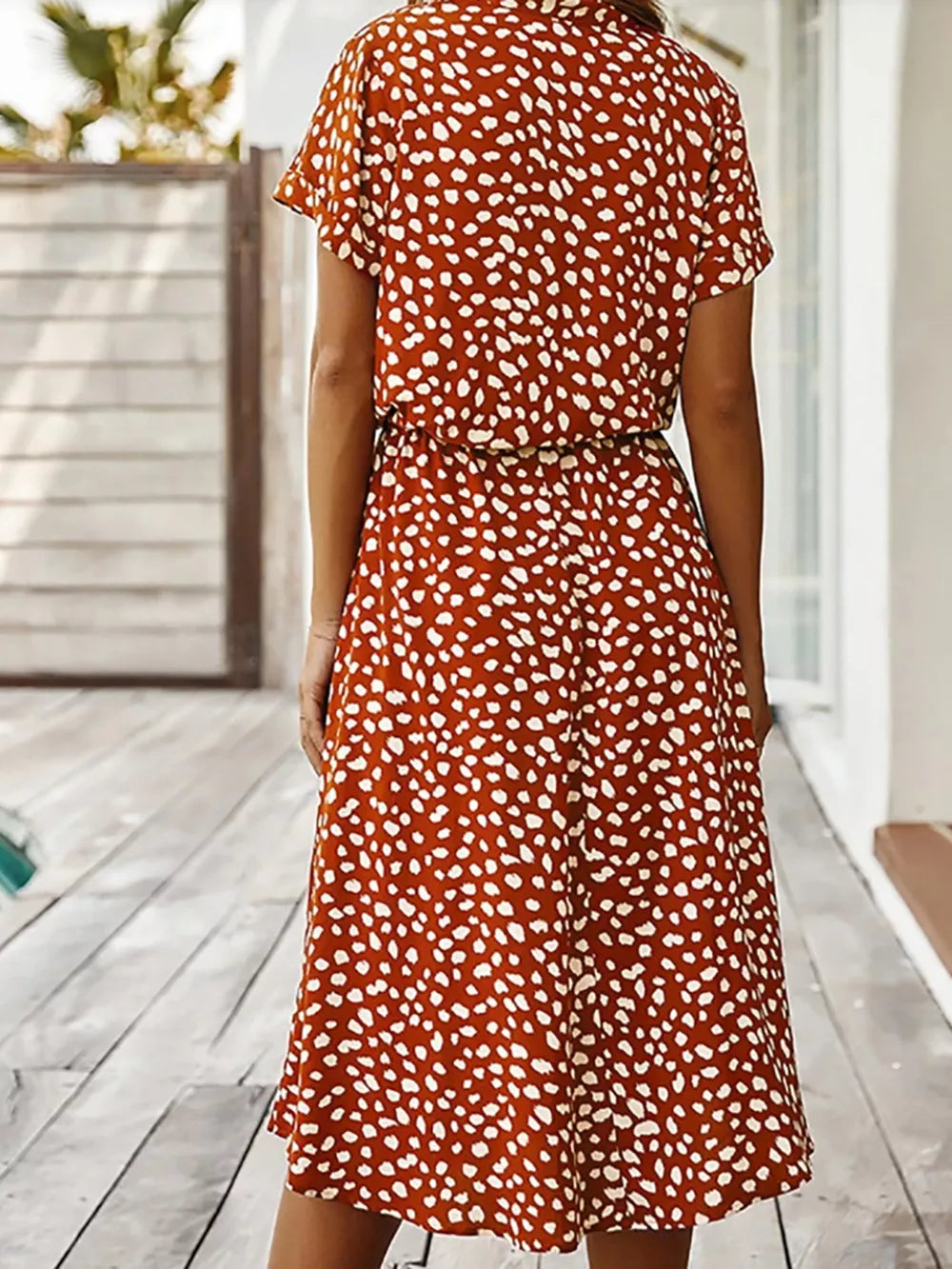 Scarlet polka dot midi dress with short sleeves and pockets, cinched waist.