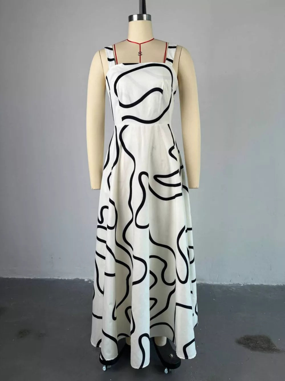 White abstract patterned midi dress with square neckline and spaghetti straps.