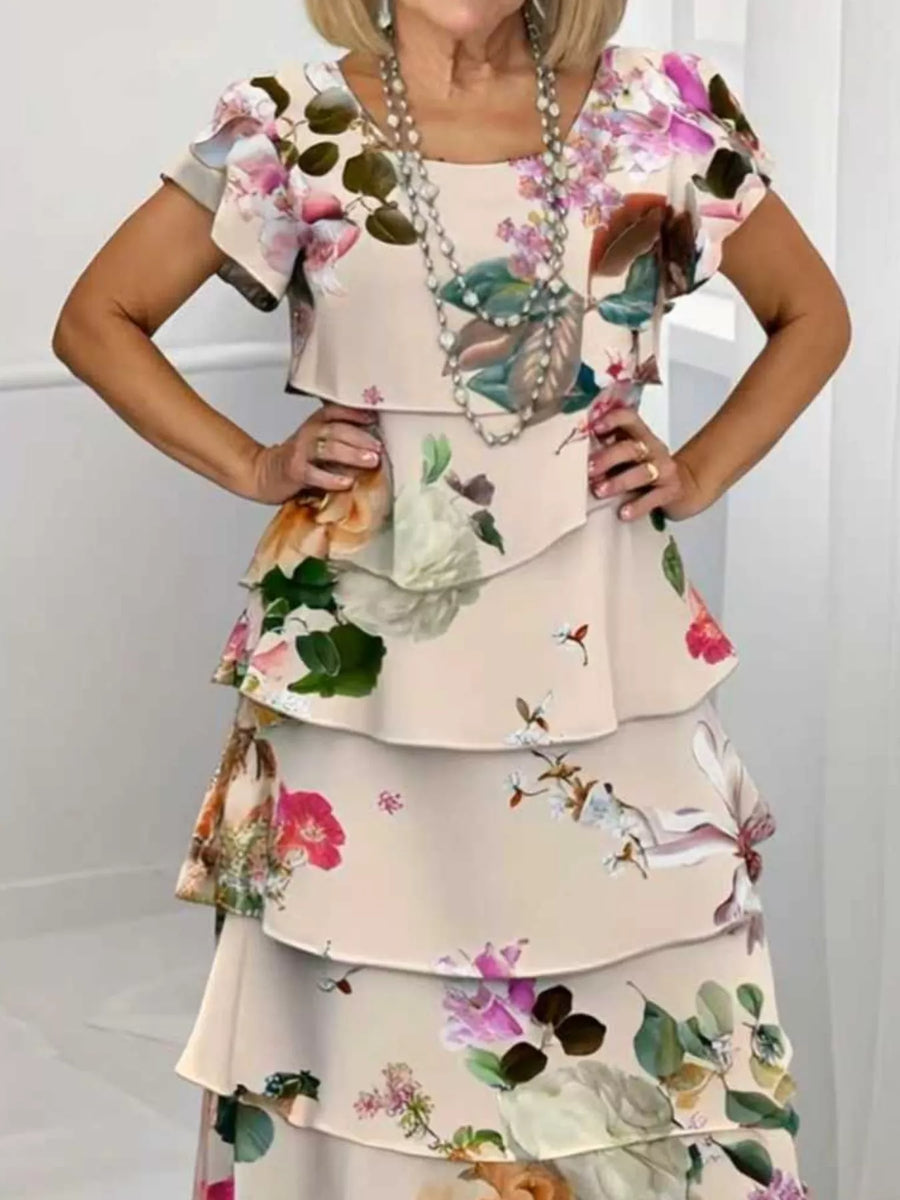 Ruffled tiered maxi dress in tan with a floral print, flutter sleeves, and square neckline.