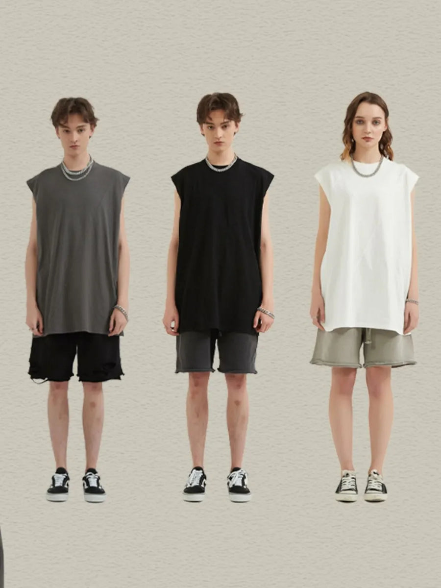 Sleeveless asymmetric panel tank top in black, white, or dark gray. Casual, bold style.