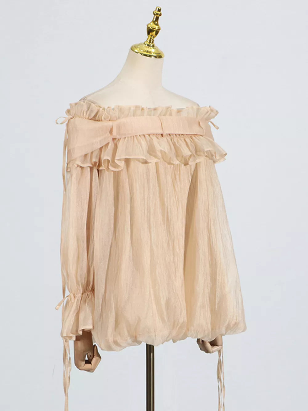 Romantic off-shoulder ruffled blouse in champagne color with tie details