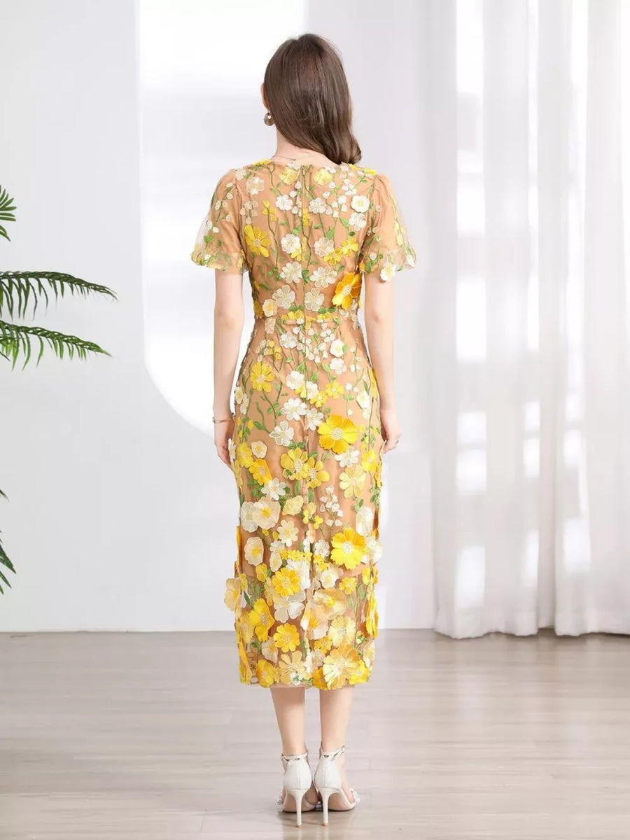 Sheer floral embroidered midi dress with short sleeves and a round neckline.