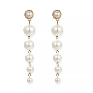 Gold cascading pearl drop earrings with multiple pearl sizes.