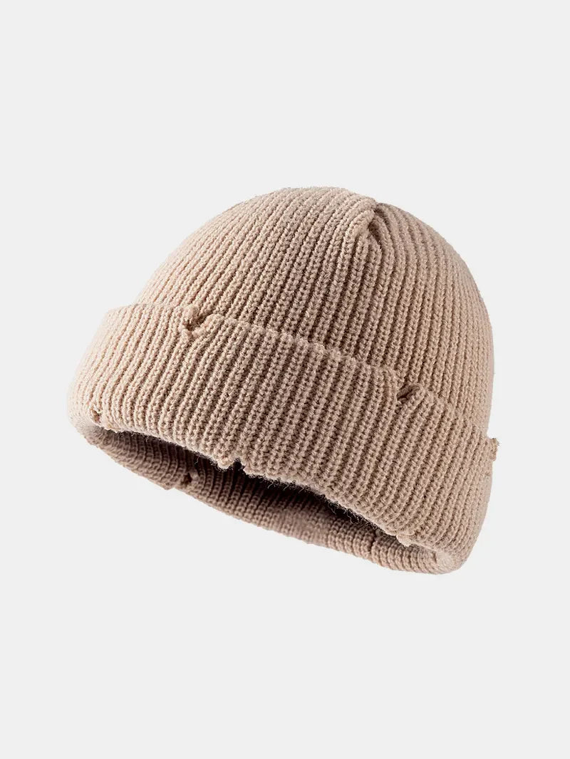 Khaki ribbed knit beanie with distressed details and a cuffed brim.