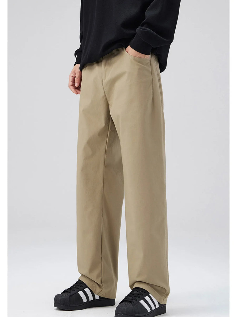 Khaki oversized casual pants with loose fit and cotton blend material.