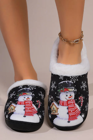 Black faux fur lined slippers with snowman print and snowflakes.