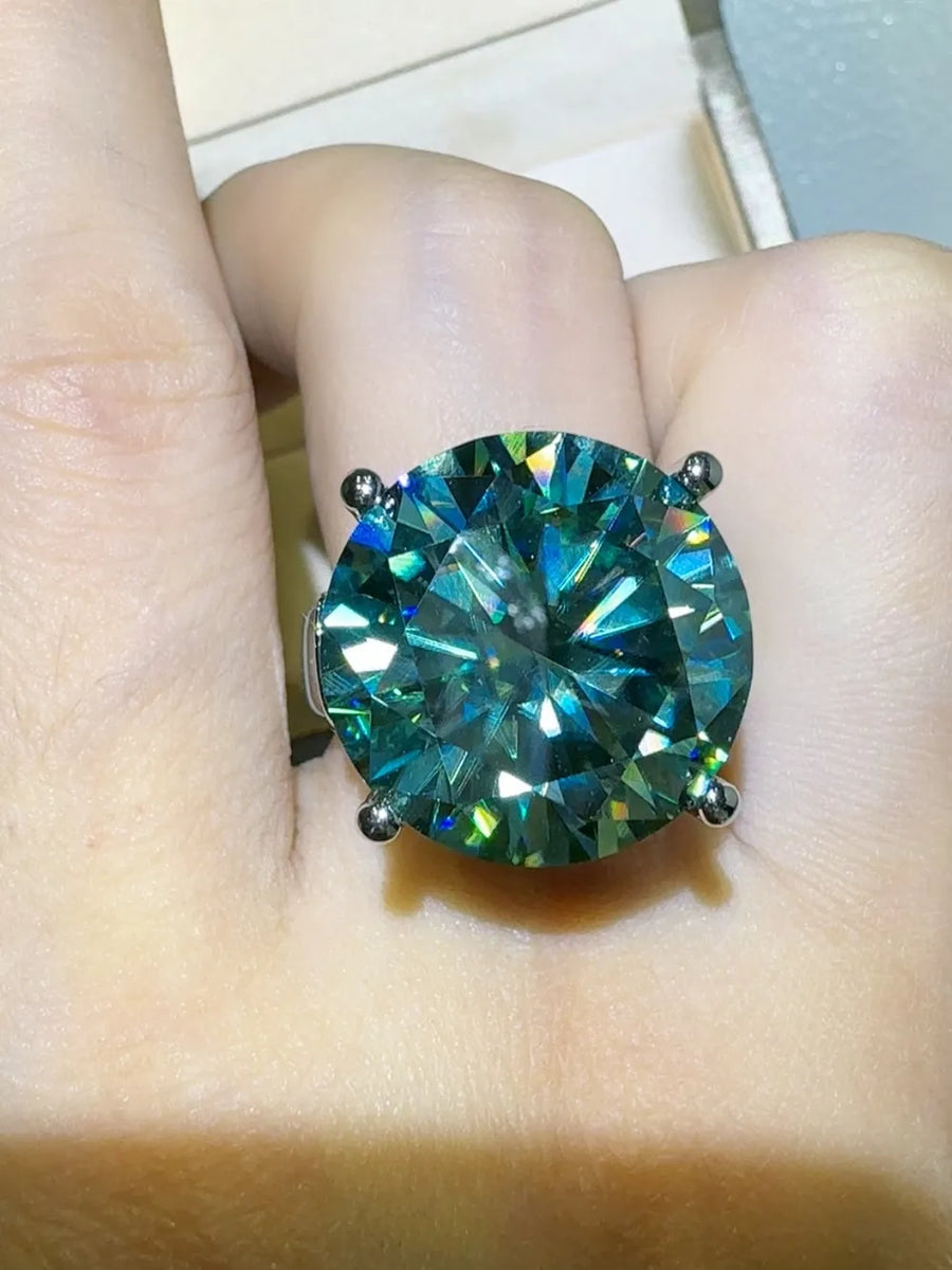 Prismatic teal statement ring with a large round-cut gemstone on a silver band.