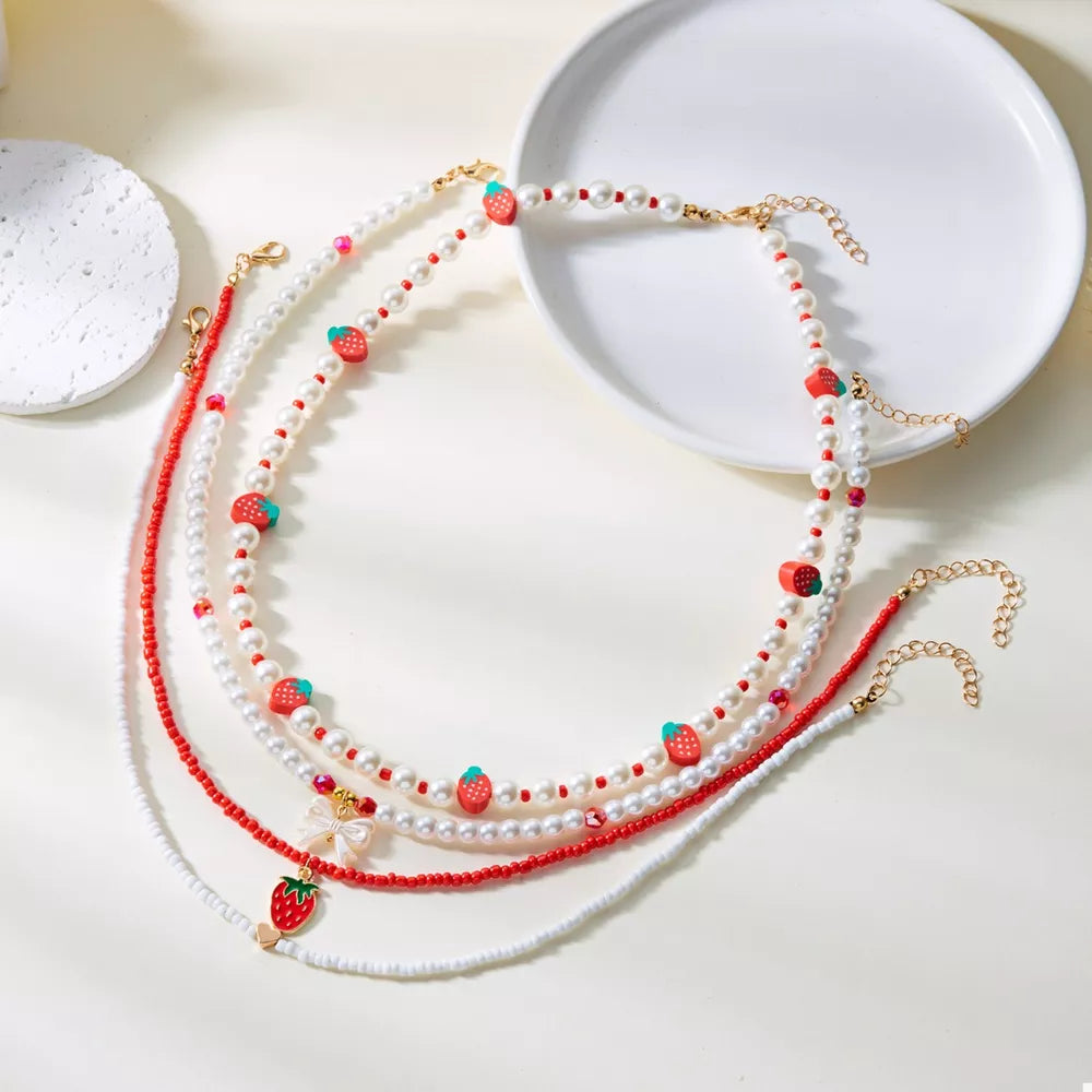 white necklace with novelty and n/a