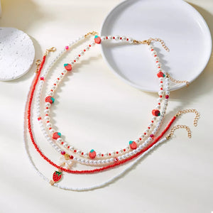 white necklace with novelty and n/a