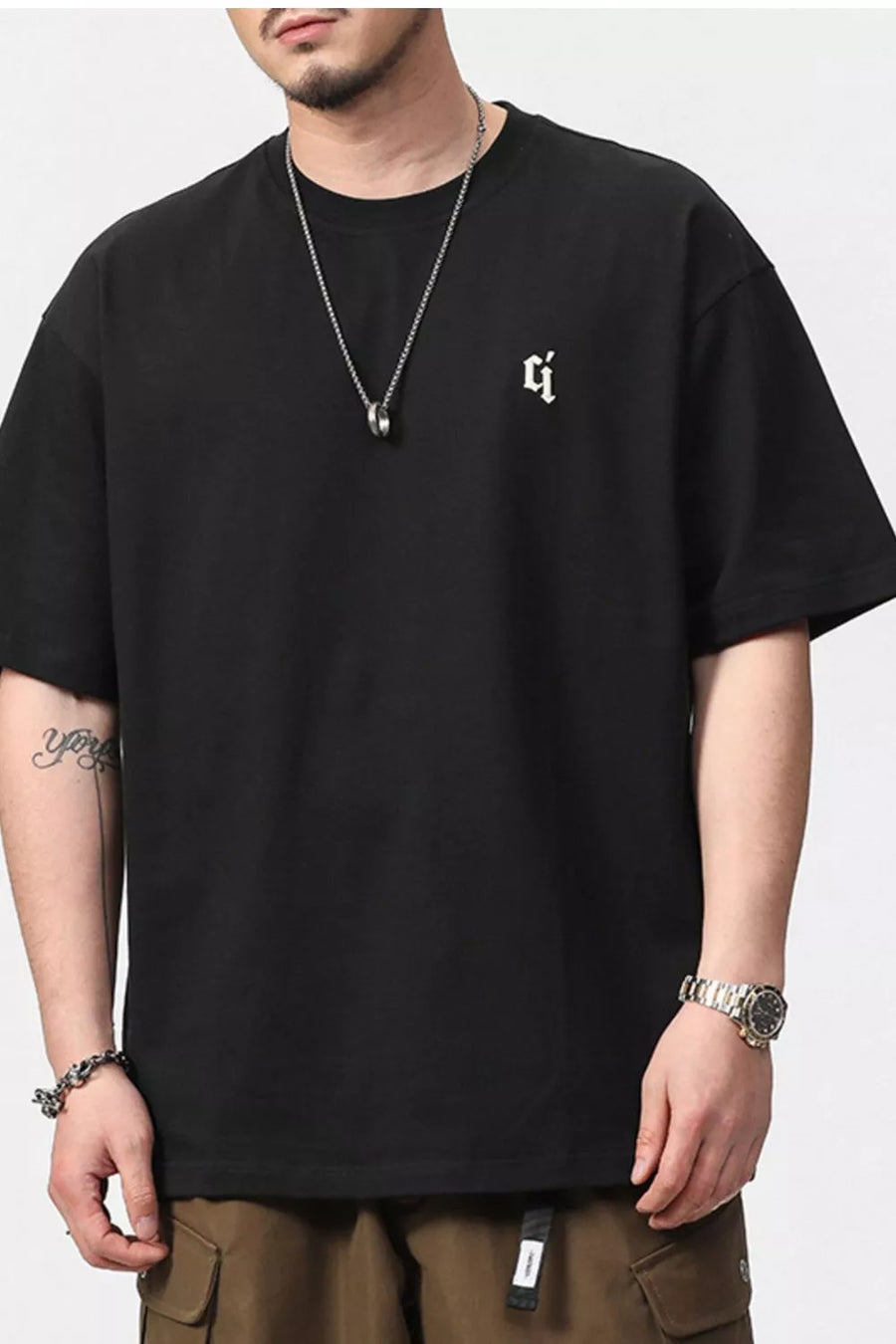 Black cotton blend tee with small white gothic logo detail on chest.