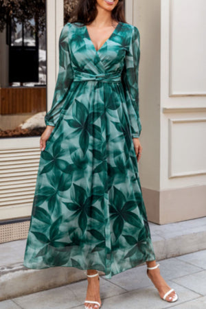 V-neck wrap maxi dress in green botanical print with long sleeves and a tie waist.