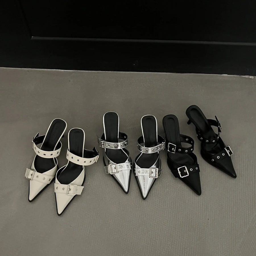 Metal pointed buckle mules in silver, beige, and black with strap details.