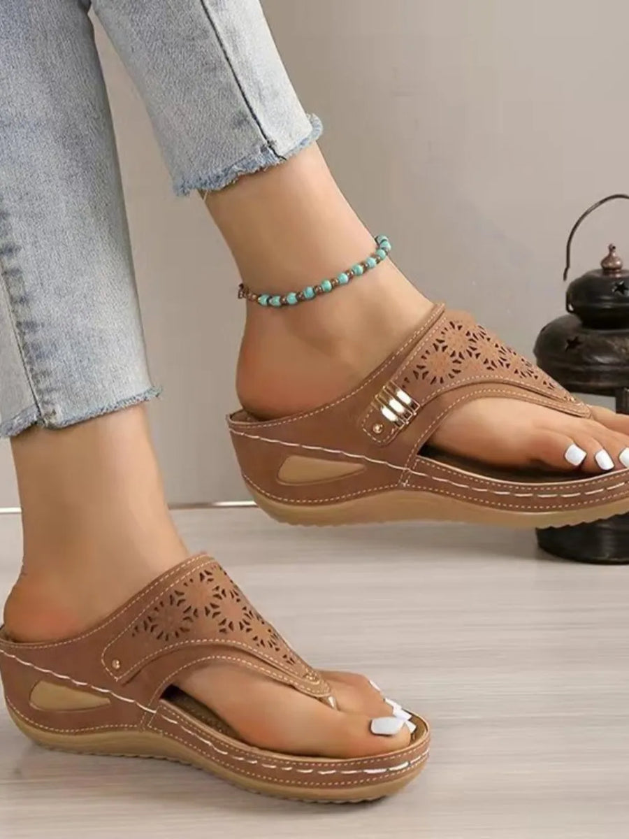 Camel laser-cut thong sandals with white stitching and a wedge heel.