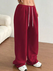 Burgundy wide-leg joggers with drawstring waist and pockets.
