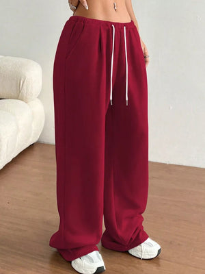 Burgundy wide-leg joggers with drawstring waist and pockets.