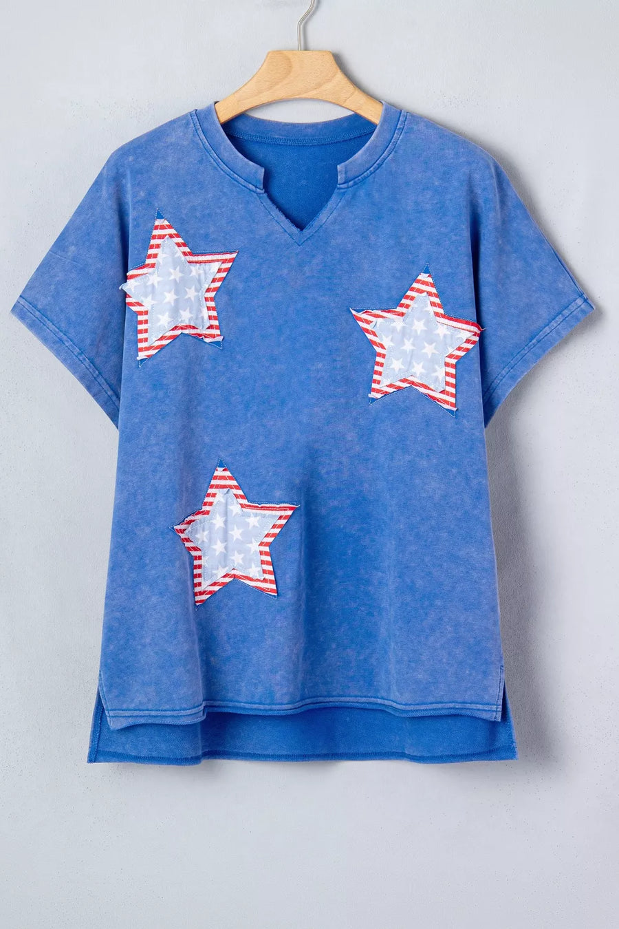 Blue cotton t-shirt with notched neck and patriotic star appliqués.