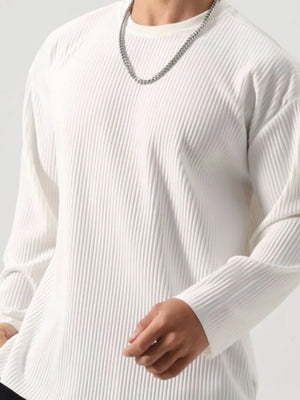 White ribbed long sleeve oversized tee with crew neck, styled with a silver chain.