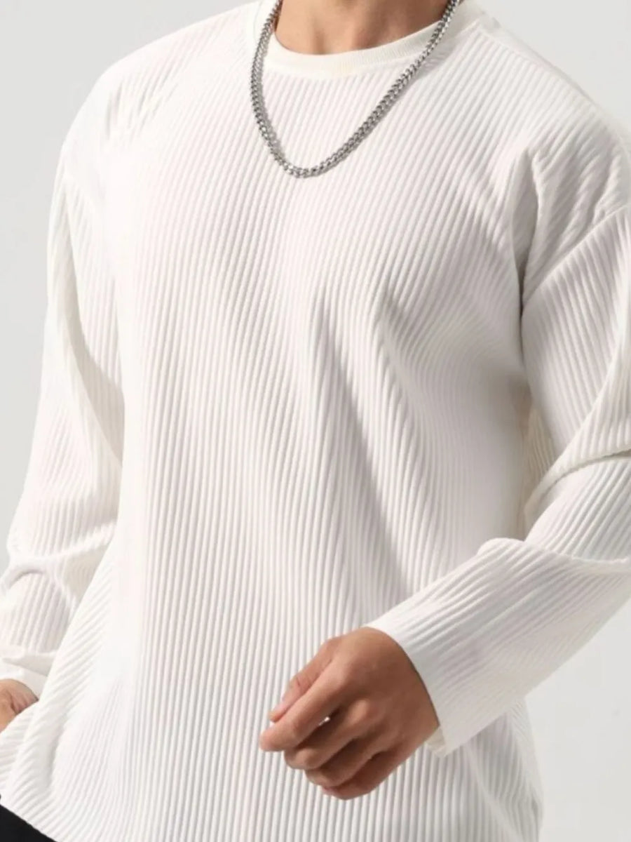 White ribbed long sleeve oversized tee with crew neck, styled with a silver chain.