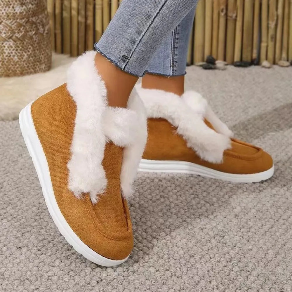 Brown suede slip-on booties with white shearling trim and white soles.
