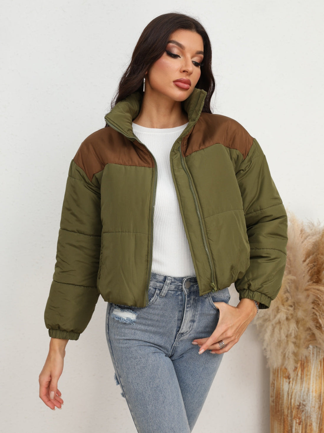 Colorblock cropped puffer jacket in army green with brown accents, stand collar, and zip front.