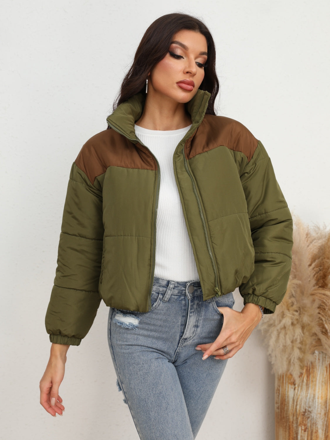 Colorblock cropped puffer jacket in army green with brown accents, stand collar, and zip front.