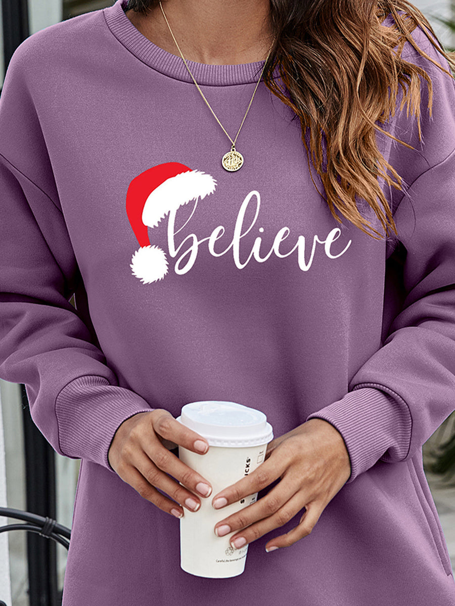 Dusty Purple Christmas graphic tunic sweatshirt with "believe" text and Santa hat graphic.