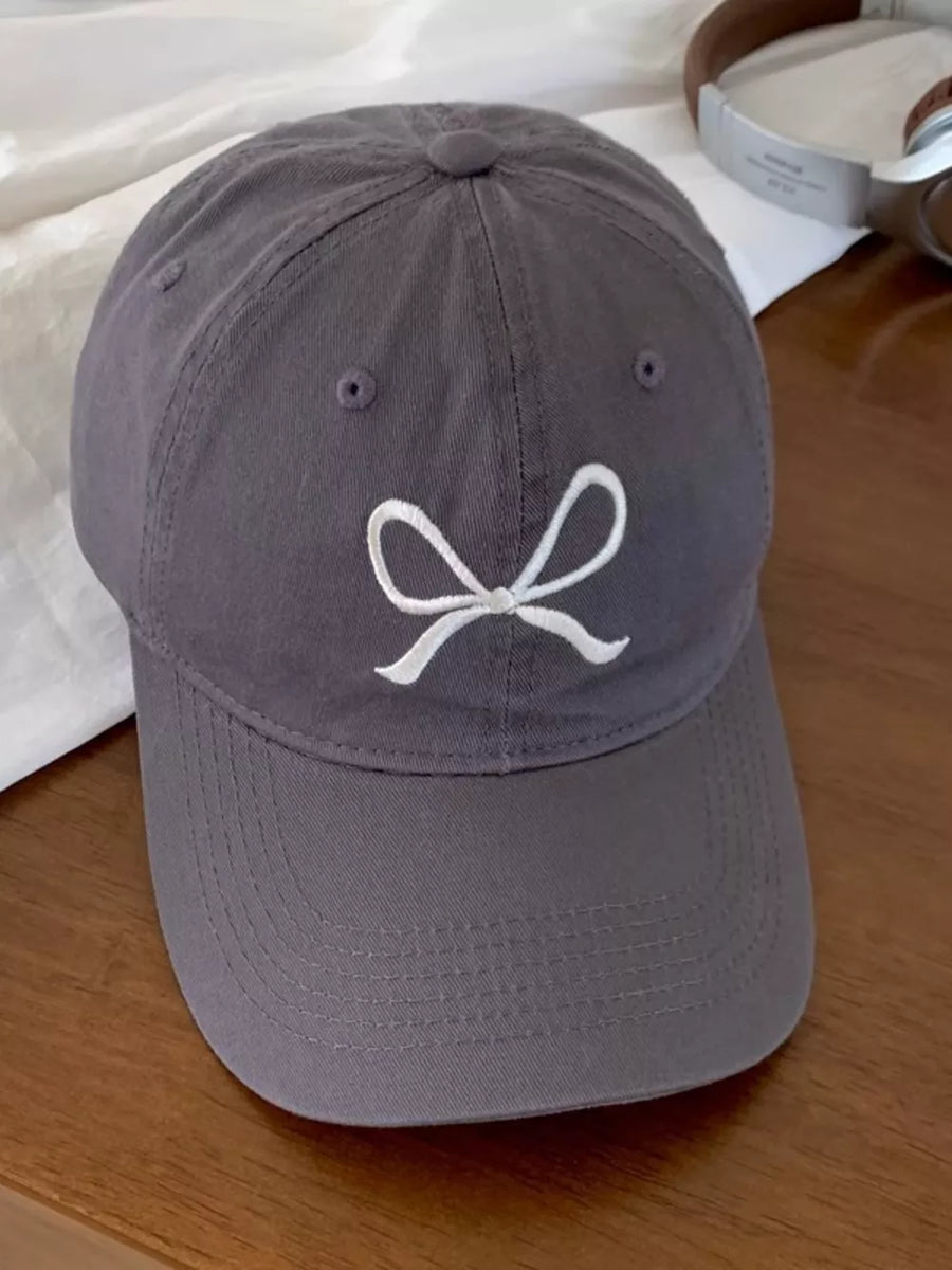 Grey baseball cap with white embroidered bow detail