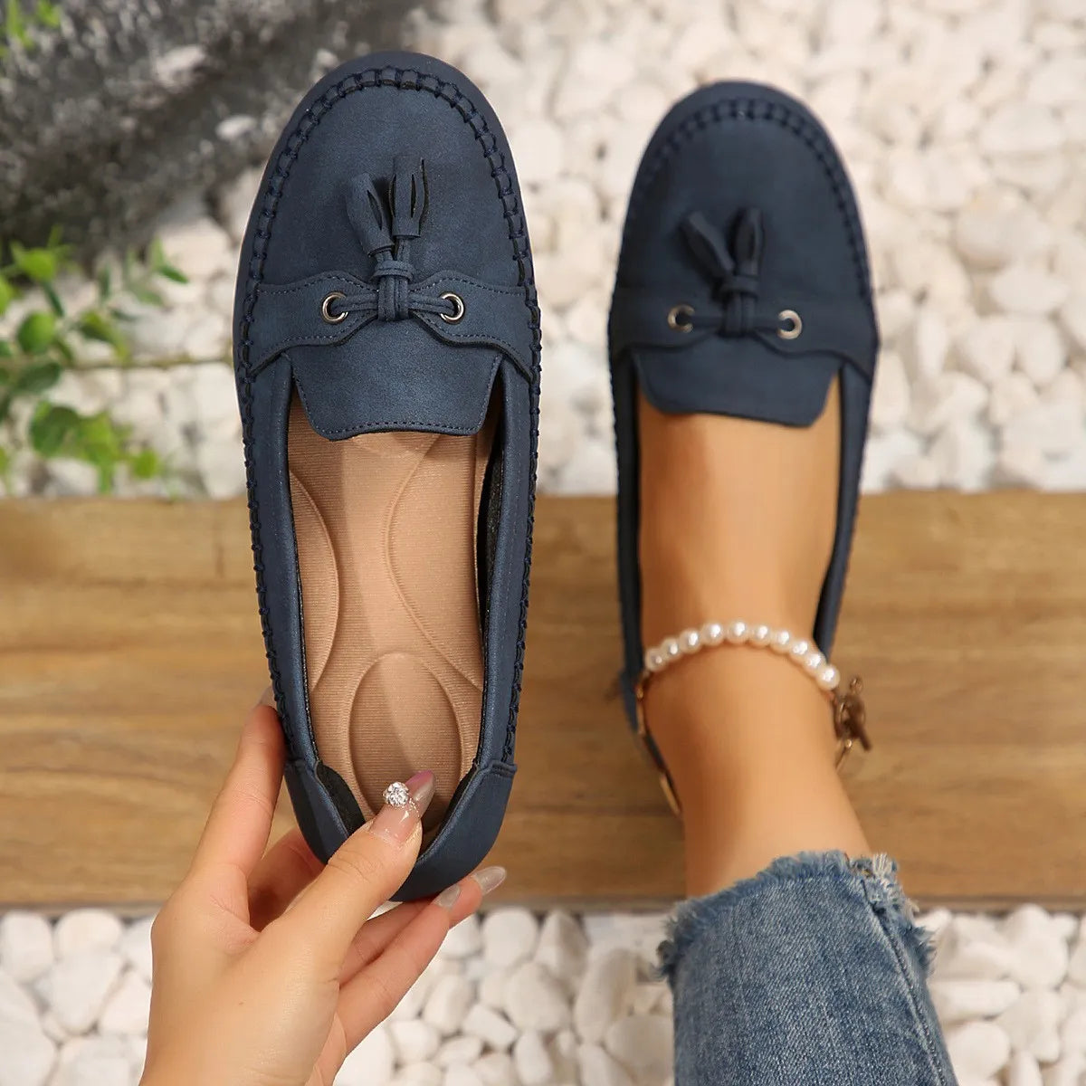 Dark Navy suede loafer flats with tassel detail and metal accents.