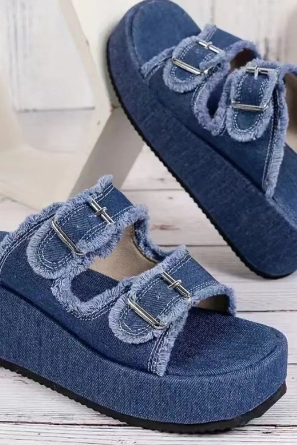 Denim platform buckle slides in blue with frayed edges and silver buckles.