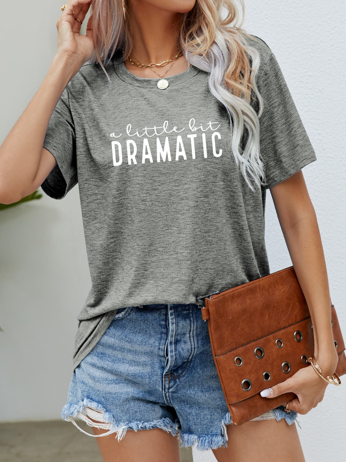 Heather gray crew neck tee with white "a little bit DRAMATIC" graphic text.