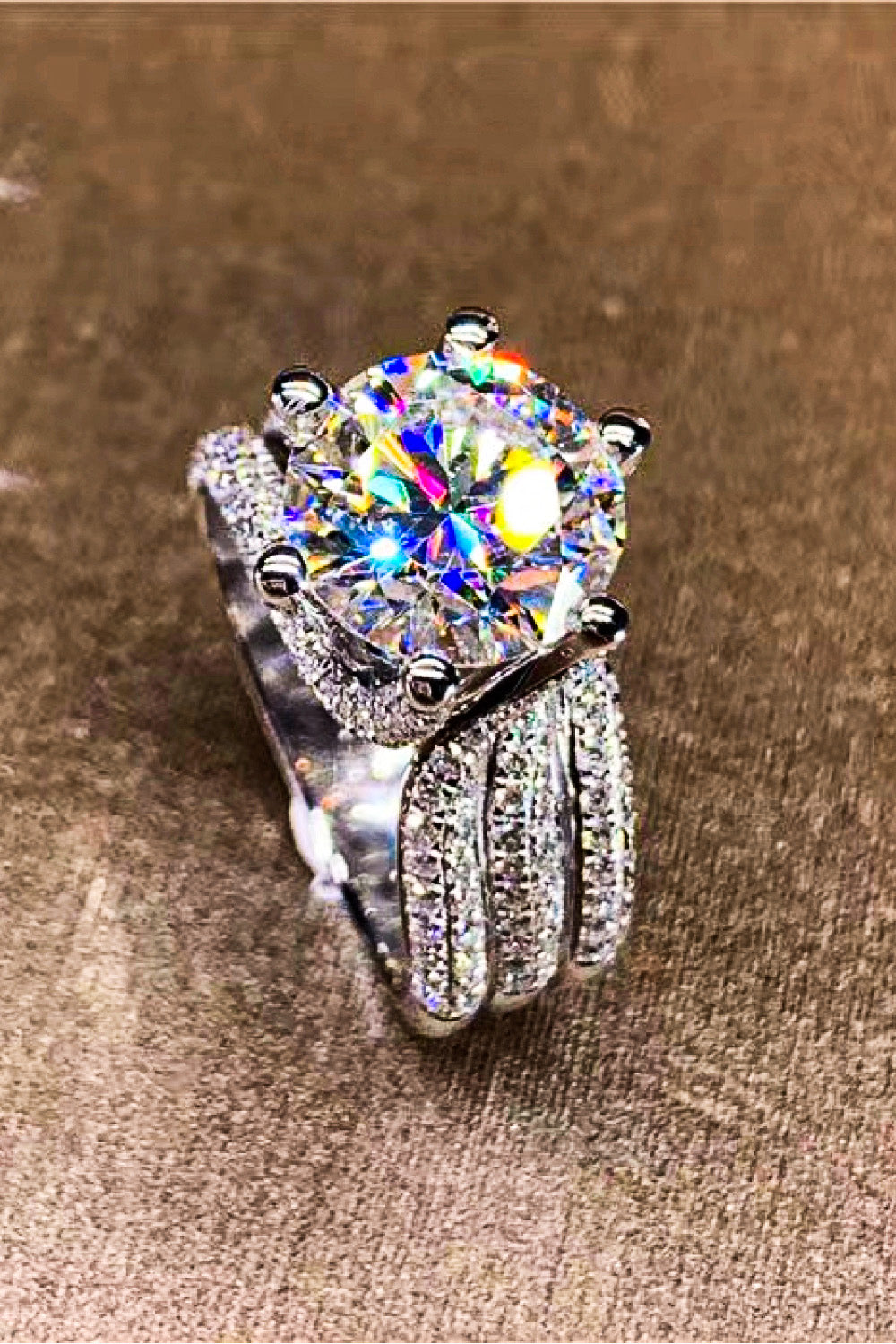 Silver pavé halo moissanite engagement ring with a large center stone.
