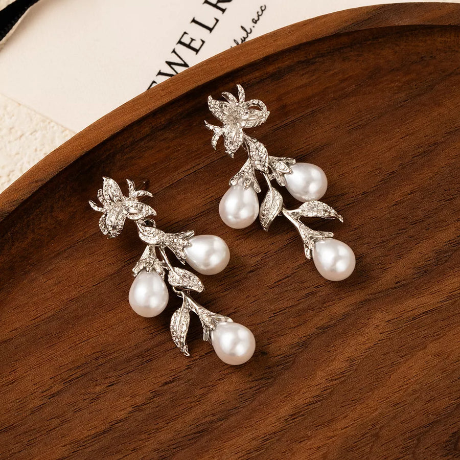 Synthetic Pearl, Zinc alloy, Silver-plated Care instructions: Avoid wearing duri earrings in Silver with dangling silhouette