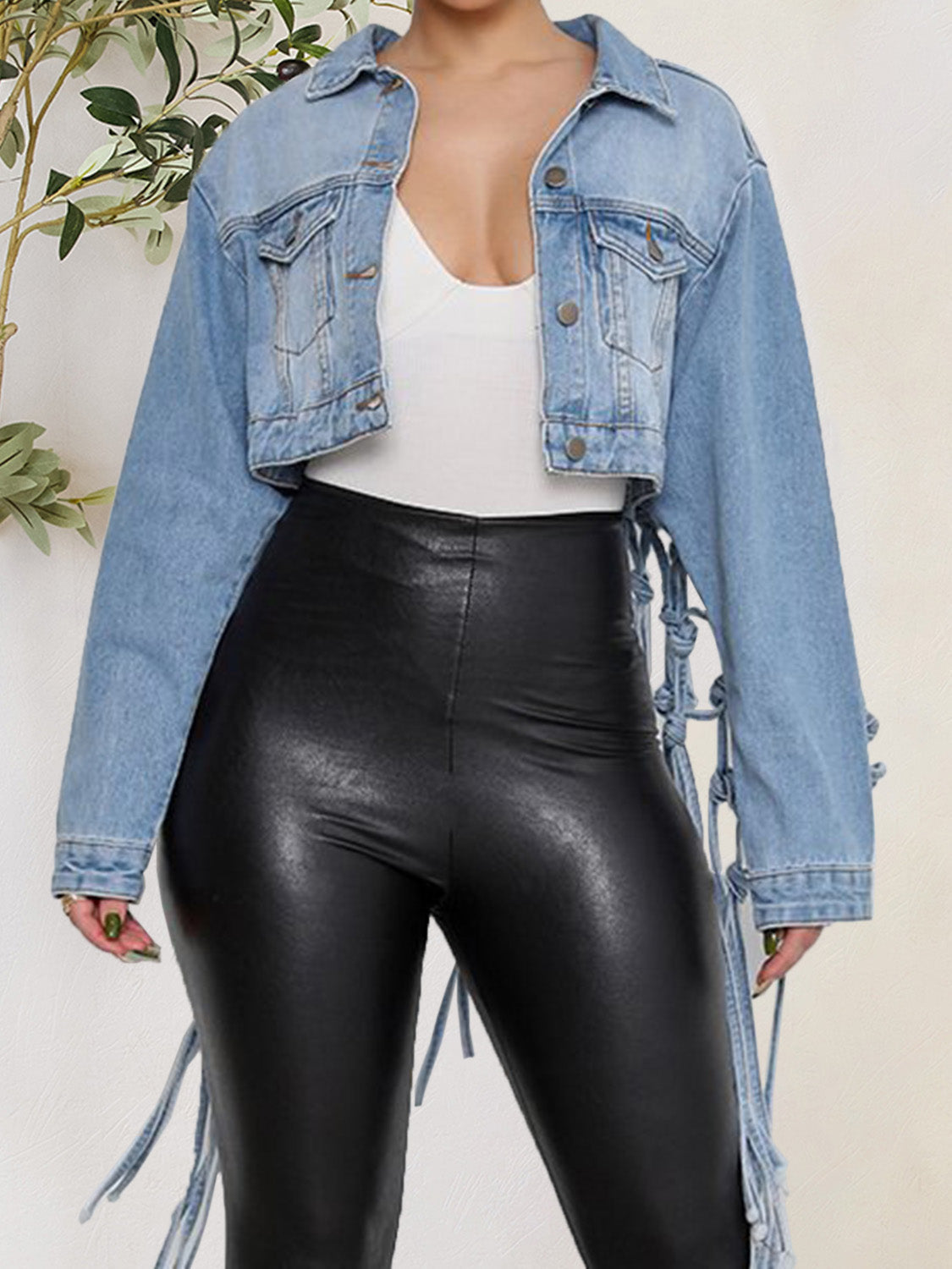 Cropped denim trucker jacket in medium wash with macramé back detail and tie accents.