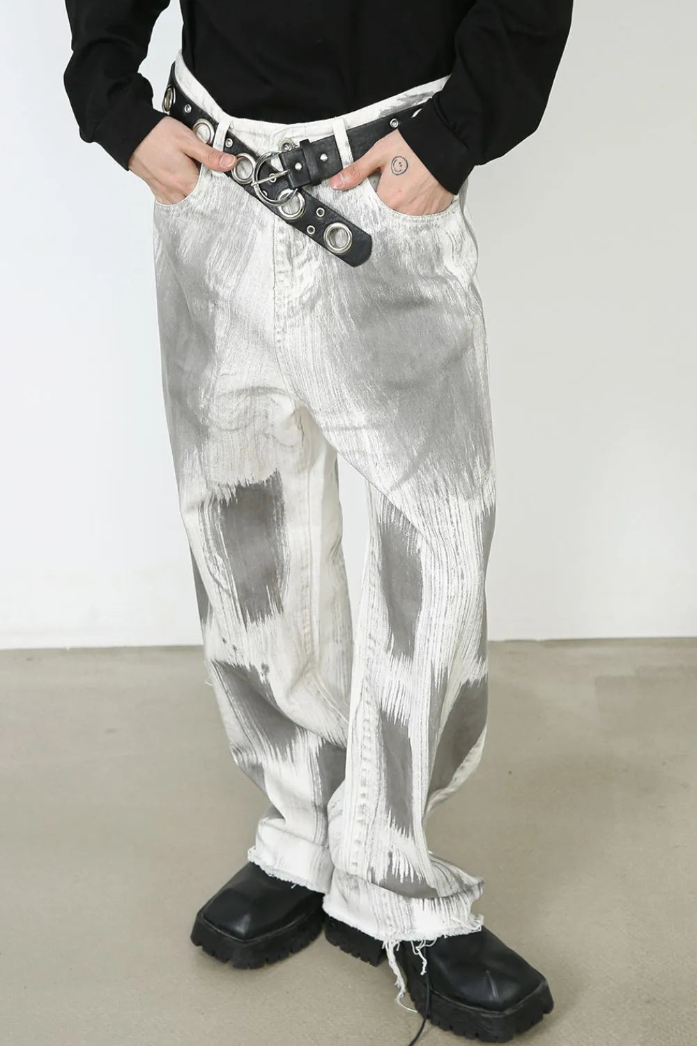 Brushstroke denim wide leg jeans in light with raw hem and abstract grey pattern.