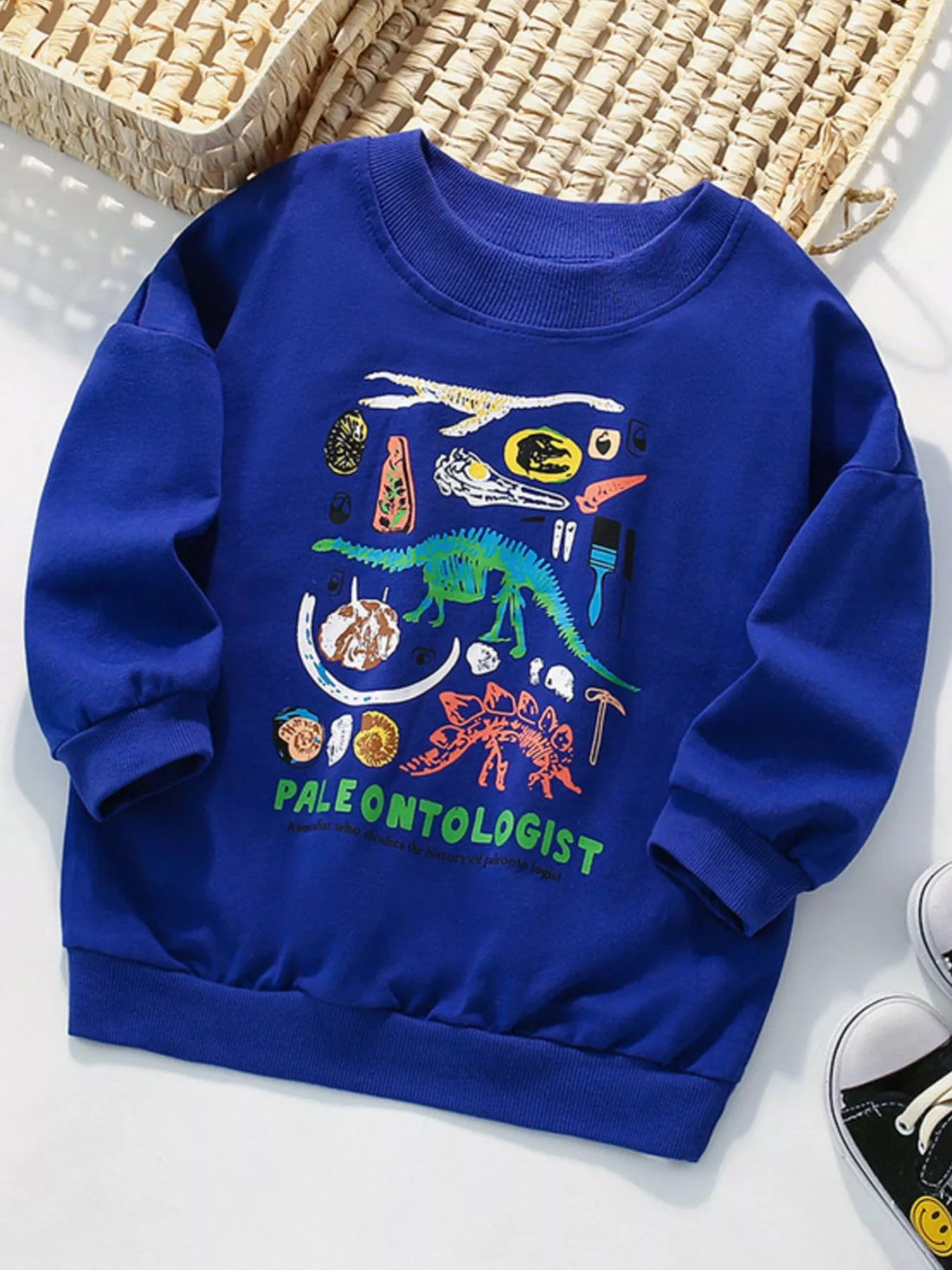 Kids' blue sweatshirt with dinosaur graphic and paleontologist text