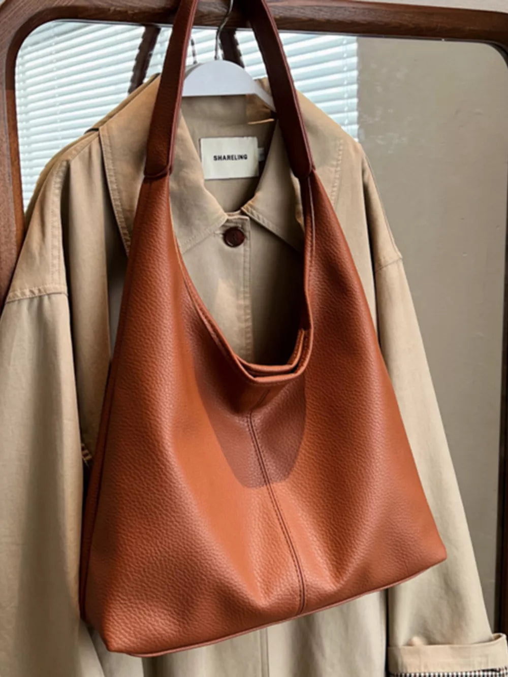 Brown pebbled leather hobo shoulder bag with slouchy silhouette and comfortable strap.