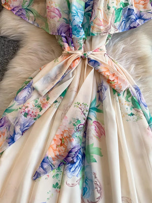 Botanical off-shoulder dress in light pink with floral print and belted waist detail.