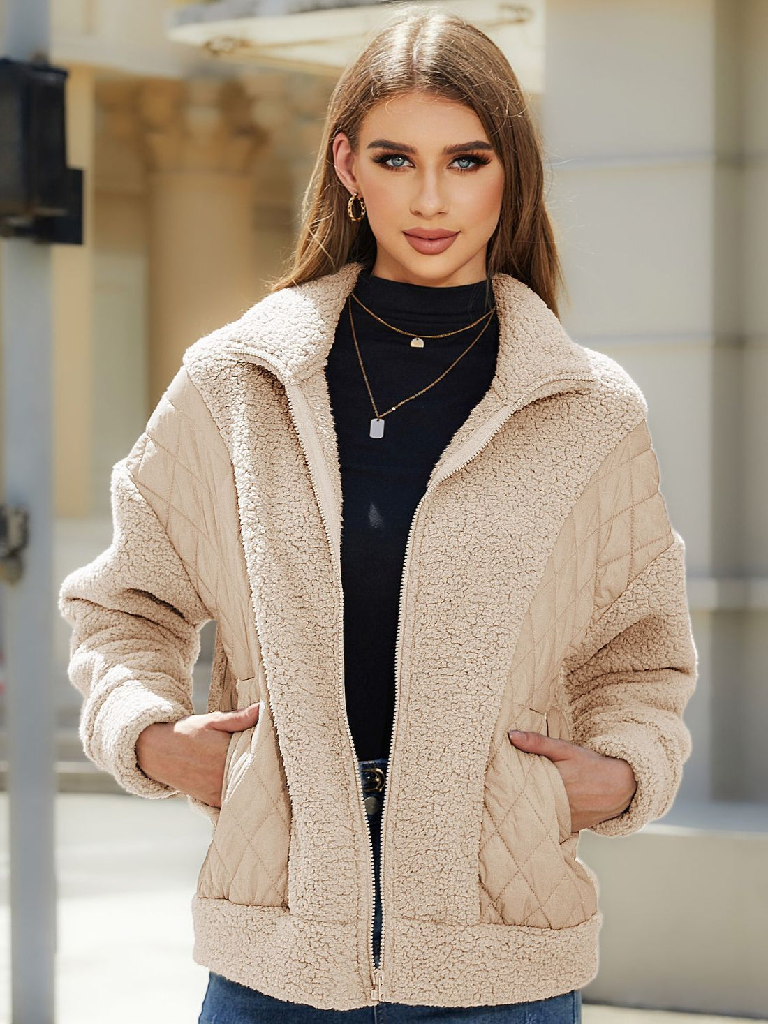 Camel quilted jacket with sherpa panels and zip front, styled with a black turtleneck.