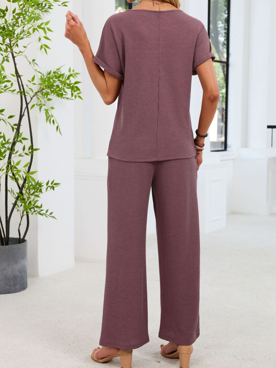 Plum purple waffle knit two-piece set with short sleeve top and wide leg pants.