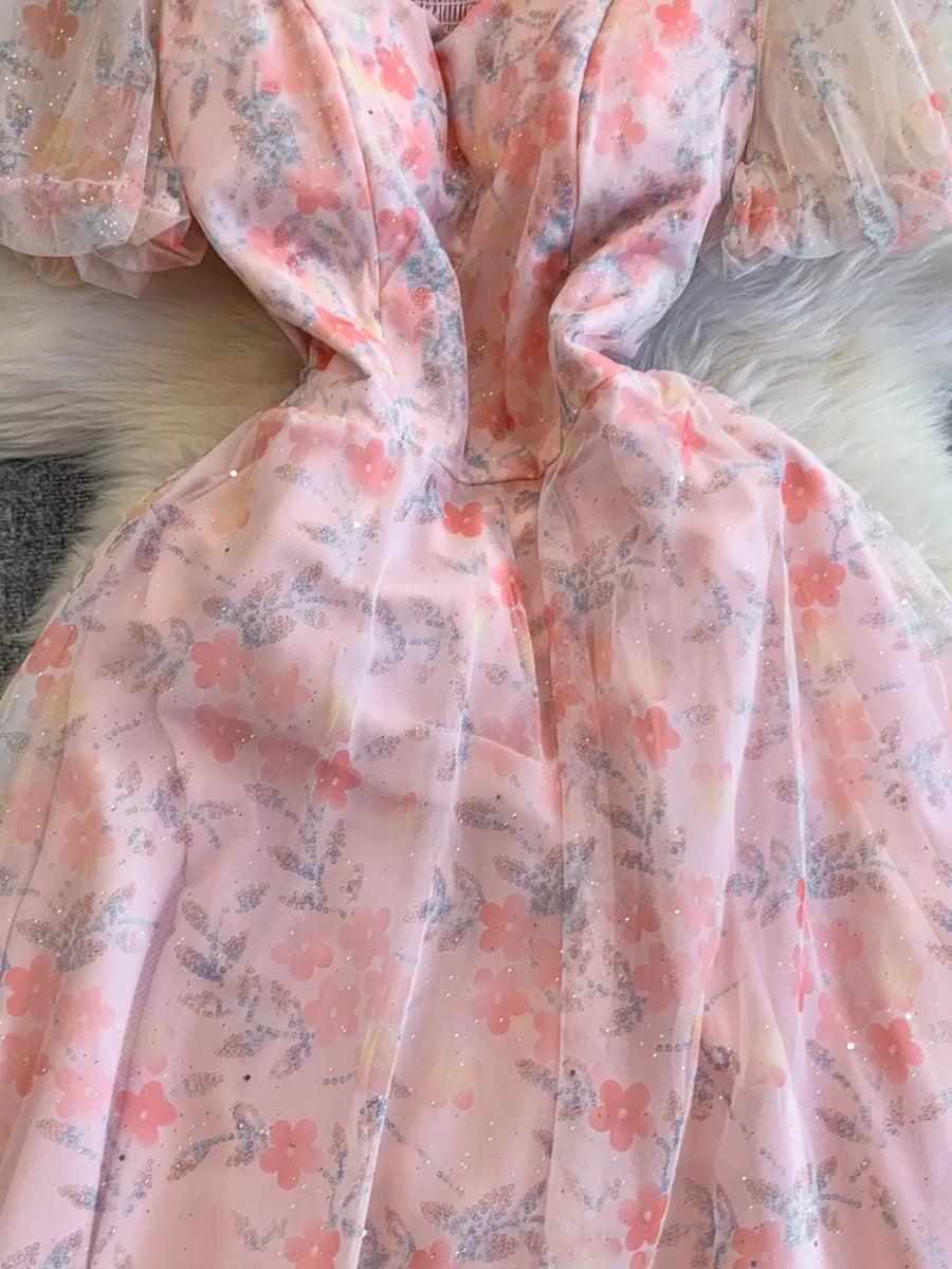 Light pink floral maxi dress with sweetheart neckline and sheer puff sleeves.