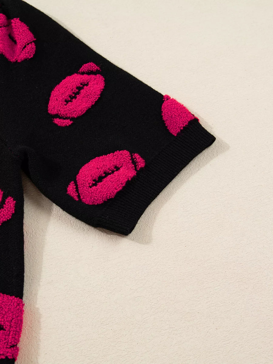 Black short-sleeve knit sweater with all-over fuzzy pink lips pattern.