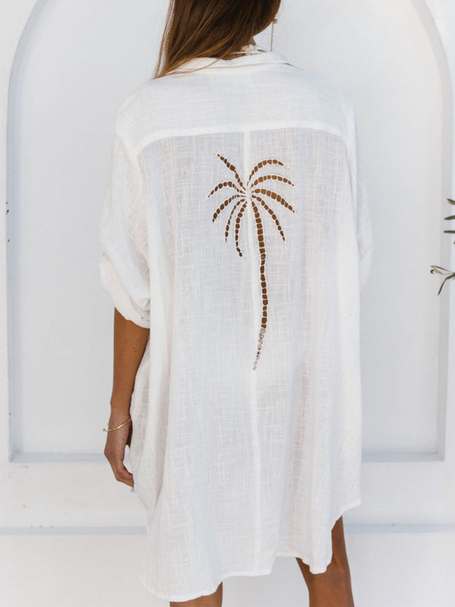 White cotton blend button-down shirt dress with palm tree cutout detail on back.