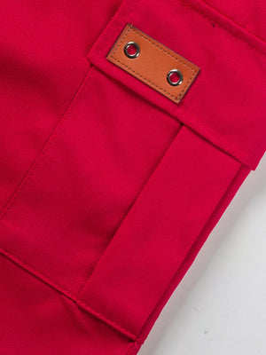 Deep red cargo shorts with adjustable detail and leather tab.