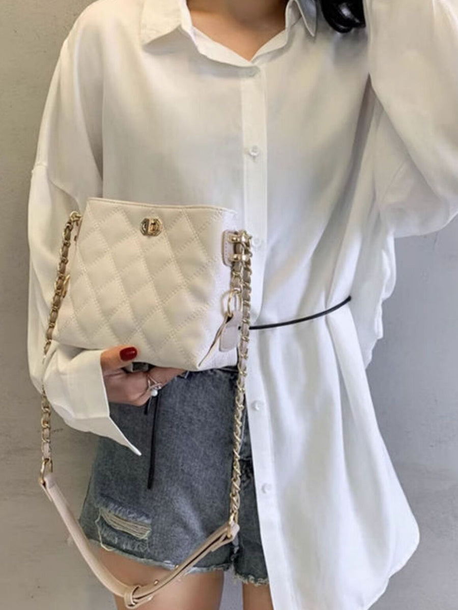 White quilted pu leather crossbody bag with gold chain strap and clasp detail